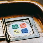 Wooden voting panel with multilingual buttons in Bern's Parliament, Switzerland.