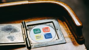Wooden voting panel with multilingual buttons in Bern's Parliament, Switzerland.